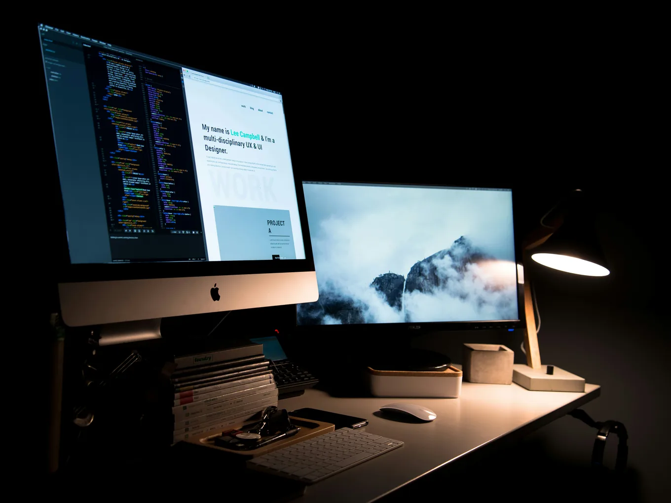 A desk at night, a website open on the screen it is being built on.